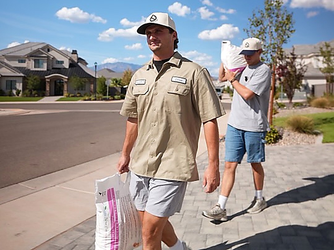 True Water Utah carrying salt bags to a customer's home in Utah County