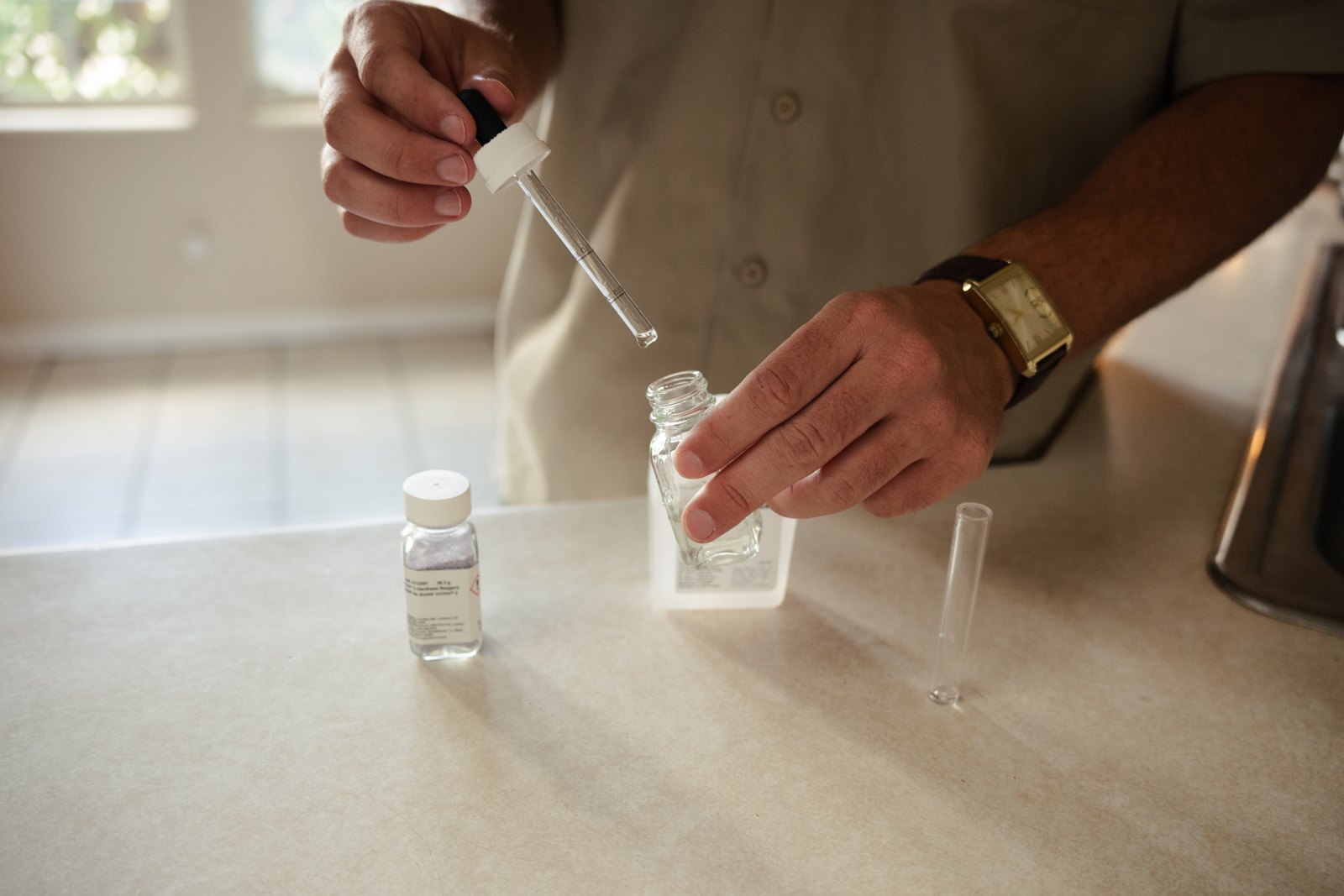 True Water Utah technician running a hardness test at a customer's kitchen counter
